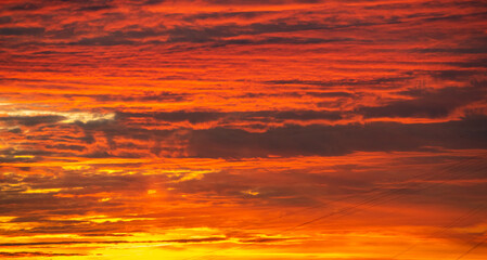 Red clouds in the morning sky in the rays of the rising sun. Sunrise.