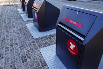 Copenhagen, Denmark Modern and clean garbage collection, sorting and seperation bins on a street in the Amager district.Sign says textiles in Danish.