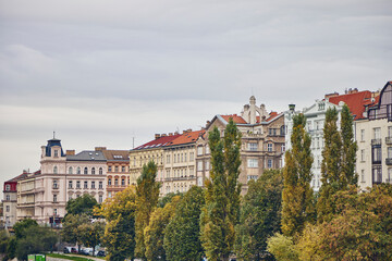 Fototapeta na wymiar Prague buildings through the trees in autumn.