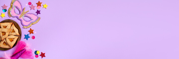 Purim carnival background with traditional cookies, costume accessories and decor on pastel violet