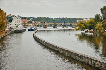 Fototapeta na wymiar Czech Vltava river and Charles Bridge in Prague during autumn.