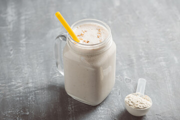 White smoothie with protein powder in a glass jar, healthy eating concept