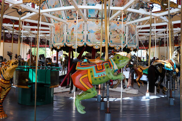 Frog ride on a Merry go Round Carousel designed for kids enjoyment at amusement parks 