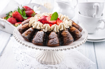 Traditional German strawberry cheese cake with fresh fruits and white chocolate cream served as close-up on a cake plate