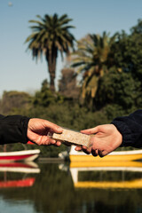 Healthy Lifestyle. Man giving a Granola Bar to another Man on the street. Healthy Snacks