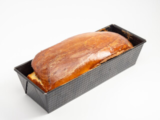 Freshly baked bread with poppy seeds in a mold.