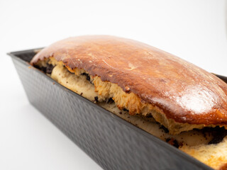 Freshly baked bread with poppy seeds in a mold.