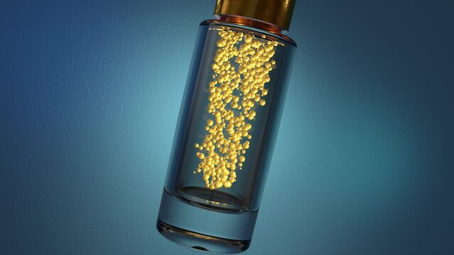 Transparent glass cosmetic bottle with a golden cap on a blue background. Inside the jar, yellow particles or bubbles move, saturating the liquid with moisturizing or nourishing cream or vitamins.