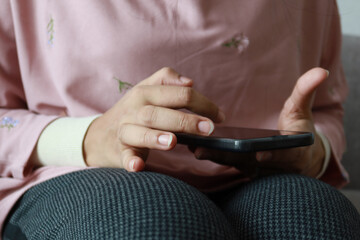close up of women hand holding smart phone 