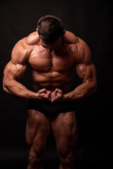 Fototapeta na wymiar A Muscled Man Flexes his Impressive Physique