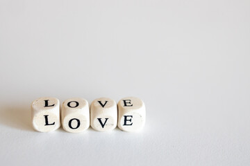 Word Love made up of wooden cubes isolated on white background