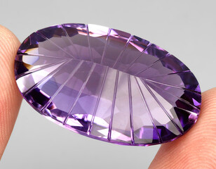 Natural gemstone purple amethyst on gray background