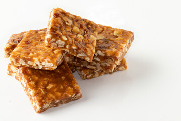 Delicious Brazilian pé de moleque on white background.