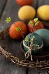 Easter eggs coloured with natural organic colorants: red cabbage, curcuma, onion peel. Handmade home decor, natural elements, eco-friendly, zero waste. Dark wooden background