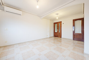 Empty room, combined light stoneware floors, with sapele doors and air conditioning unit