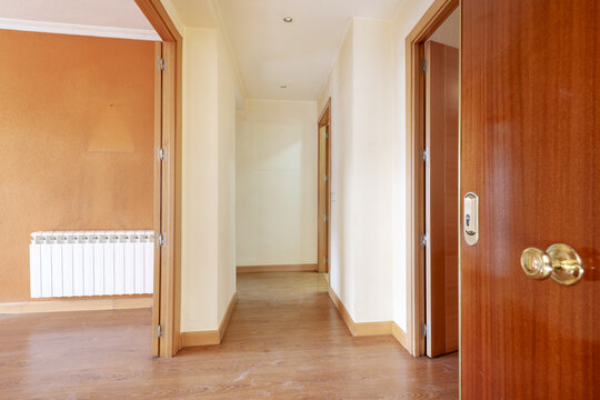 Entrance hall of a house with laminated flooring with oak woodwork inside and sapele woodwork on the outside door