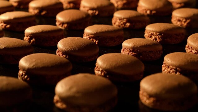Baking chocolate macaroons in electric oven. Timelapse of growing macarons. Delicious dessert. Process of cooking macaroons. Close-up in 4K, UHD