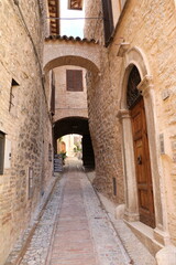 Archway in a old narrow alley in Spello, Umbria Italy