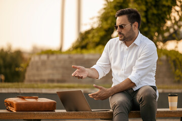  Smiling young businessman holding video call with clients partners