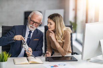 Senior engineer and technician working together on new project in modern office