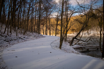 A snow-covered meandering path by the lake. Grundy Lakes of the South Cumberland State Park system in Tennessee.