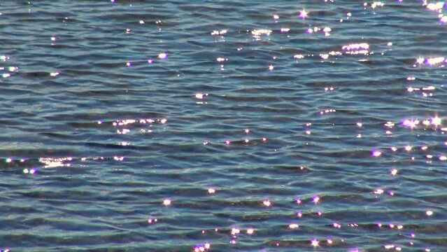 Glare on the water from the sun, in the ocean Ireland