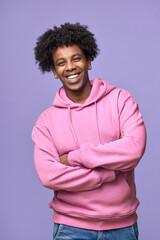 Young happy African American teen guy wearing pink hoodie isolated on purple background. Smiling...