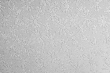 white paper background with embossed shiny flowers, copy space, textured floral pattern
