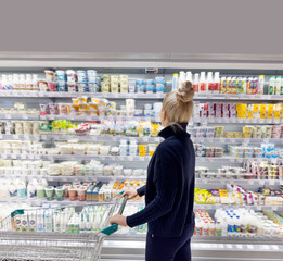 supermarket shopping,Woman choosing a dairy products at supermarket.