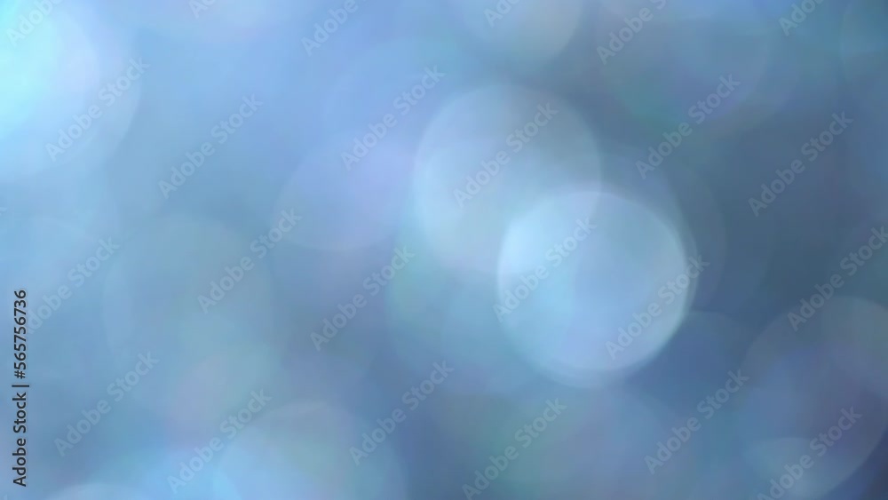 Wall mural glimmer blue bokeh moving background. fading illuminated blue defocused circles shimmer, shine and s