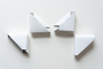 four cardboard corners (used to protect frames) on paper