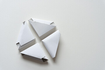 four folded cardboard corners (used to protect frames) on paper