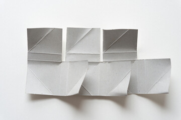unfolded cardboard corners (used to protect frames) on paper