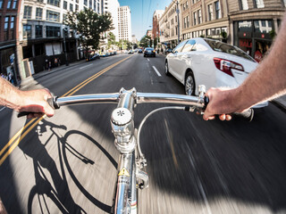 POV angle of bicycle commuting in traffic in downtown Seattle