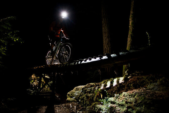 Man mountain biking at night in North Vancouver, BC