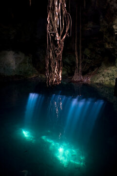 Lights illuminate a Cenote in Cuzama, Yucatan Peninsula, Mexico
