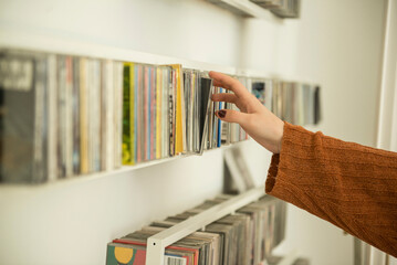 Close-up of a woman hand picking a cd from shelf, Munich, Bavaria, Germany
