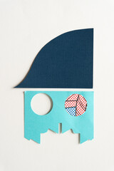 paper slope and blue paper shape with two circle cutouts
