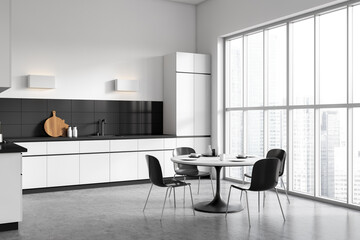 Stylish kitchen interior with eating table and seats, panoramic window