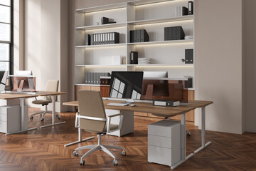 Beige business interior with pc computer and work desk near panoramic window