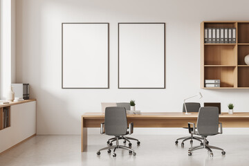 Bright office room interior with two empty white posters