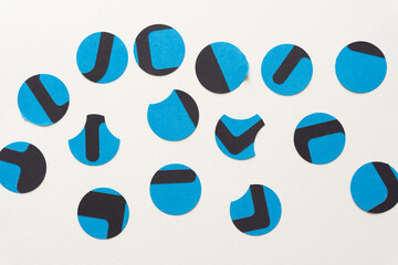 random array of paper circles with black stickers on blank paper