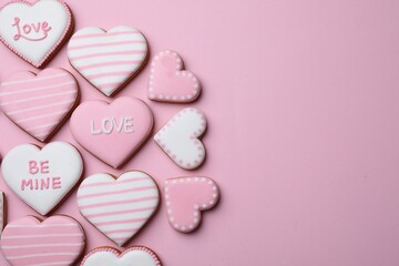 Fototapeta premium Delicious heart shaped cookies on pink background, flat lay. Space for text