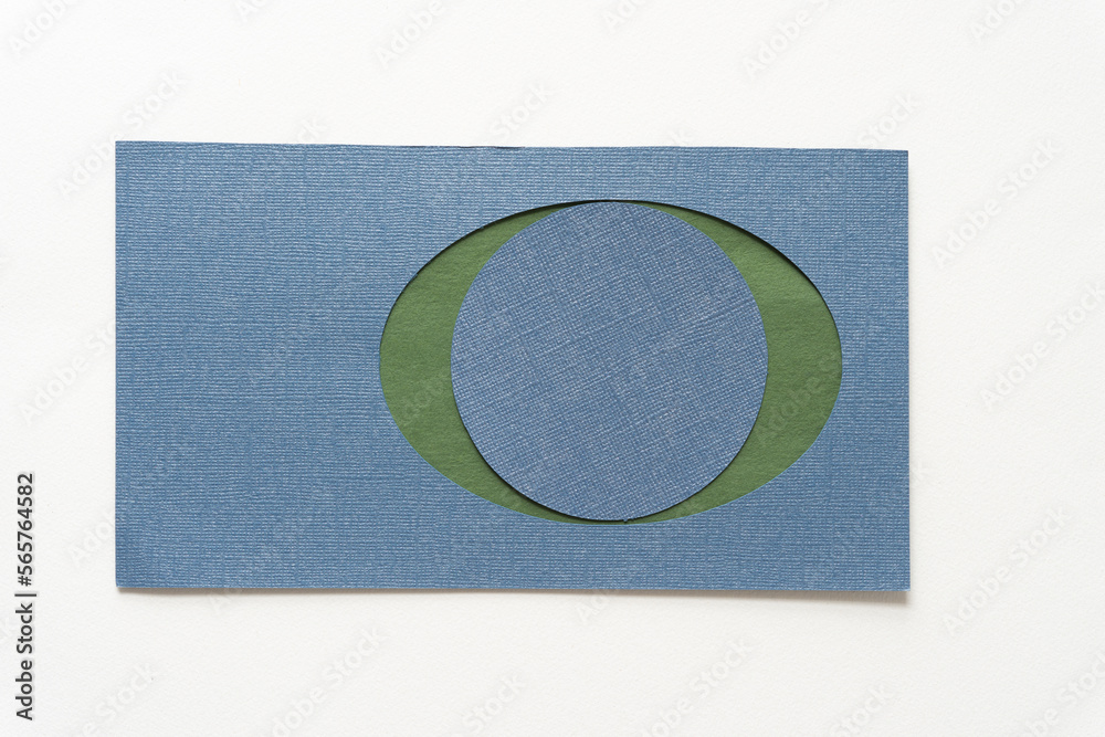 Wall mural blue oval frame with green paper backdrop and ball isolated on white