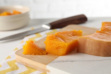 Pieces of boiled pumpkin on white table, closeup. Child's food