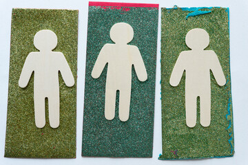 wooden stick figure silhouette cutouts on grungy glitter paper