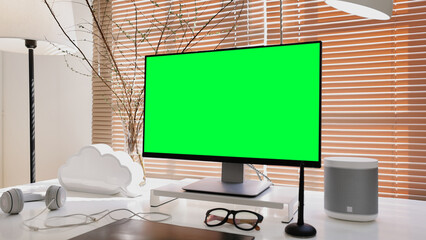Blank wide green mock up screen desktop computer monitor standing on table in the modern creative office.