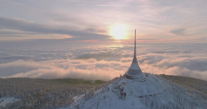 Jested tower mountain hill with snow mist and fog at golden hour