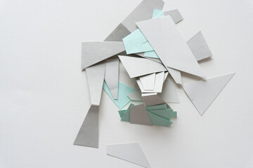 pile of folded and cut paper pieces on blank paper - macro lens, particular focus