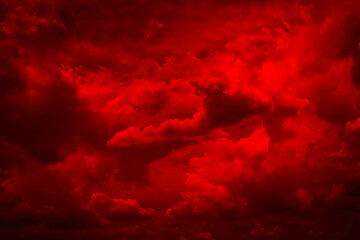 Black blood red fiery sky with clouds. Horror background for design. Dramatic frightening ominous...